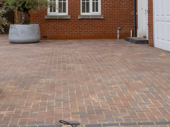 Brindle block paving driveway in front of a white double garage